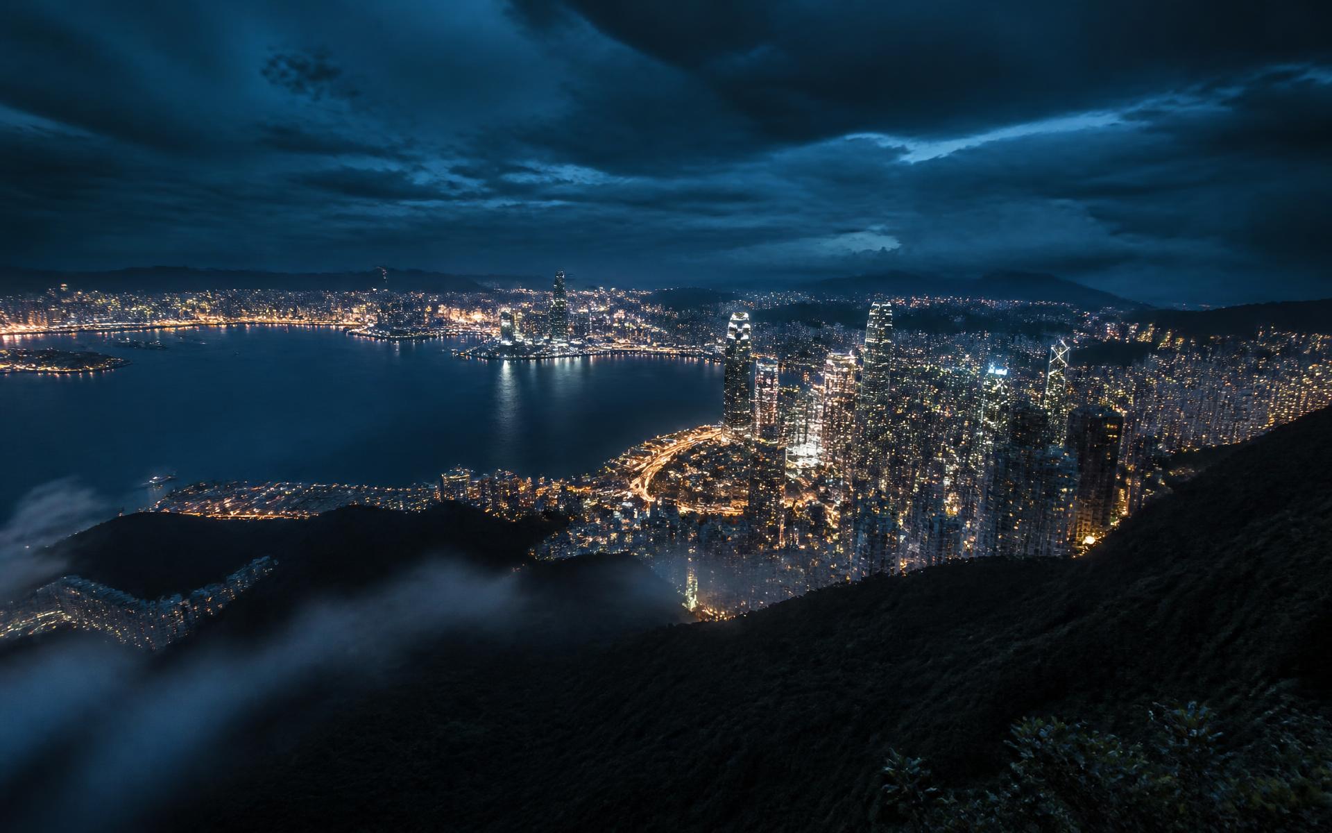 City lights at dusk seen from a mountain ridge